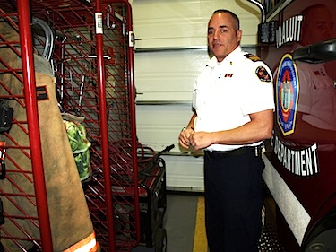 Iqaluit's acting fire chief Blaine Wiggins shows how little room is available for firefighters to get into their gear when called out to a fire. (PHOTO BY DEAN MORRISON)