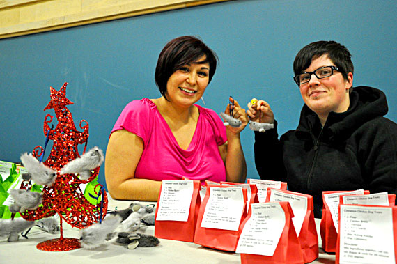 Bernice Kootoo and Laura Deal show off their handmade seal skin ornaments at the Christmas craft fair at Iqaluit's Inuksuk high school Dec. 3. More than 300 shoppers came out to stock up at the annual event. (PHOTO BY SARAH ROGERS) 