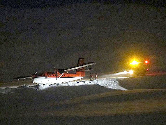 A Kenn Borek Twin Otter went off the runway in Kimmirut Dec. 6, when the cargo plane's tire reportedly blew and pushed the aircraft into a snowbank. Local residents say no one was injured. The aircraft was still stuck alongside the runway on the morning of Dec. 7. The runway was scheduled to re-open some time in the afternoon of Dec. 7. (PHOTO COURTESY OF BILLY AKAVAK)