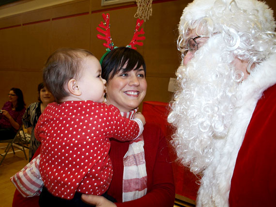 Mary Claire and her mother, Heather Guilbeault, share a smile with Santa at Joamie School's “Brunch with Santa” Dec. 4 in Iqaluit. The parent-led fundraiser featured a pancake breakfast, pictures with Santa, cotton candy, and a cakewalk. The money raised will help support music and arts programs. (PHOTO BY DEAN MORRISON)
