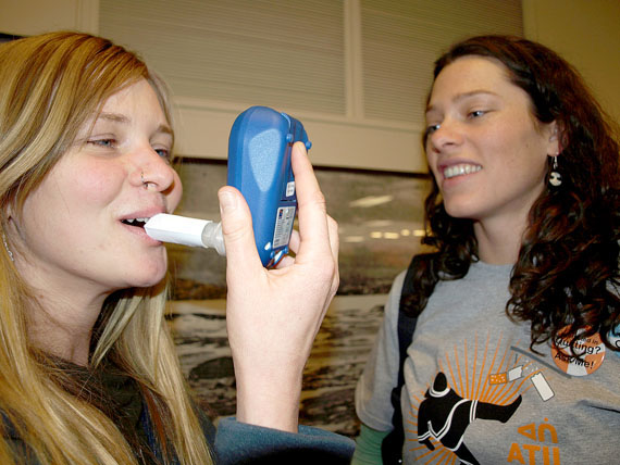 Jenn Sharman, left, a non-smoker, tests her lungs for the presence of carbon monoxide with Natasha Stephen, a public health nurse, at an educational event held Jan. 21 in Inuksuk High School. Sharman registered only one part per million - smokers will register anywhere between 17 ppm and 59 ppm, depending on how frequently they smoke. (PHOTO BY DEAN MORRISON)