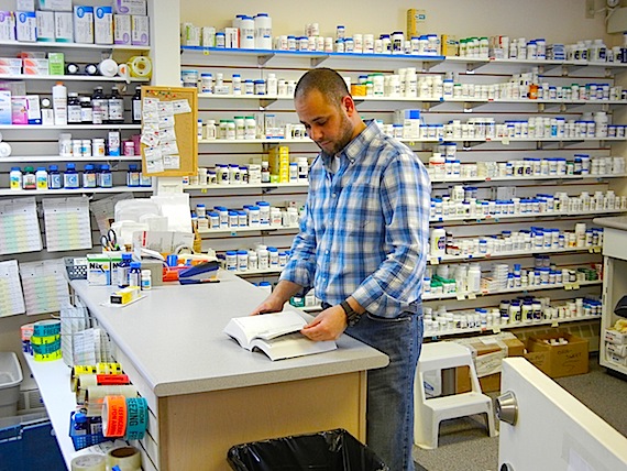Pharmacist Ehab Meshrif reads up on a medication at Kitnuna's pharmacy in Cambridge Bay. The pharmacy, whose contracts with the Government of Nunavut have been renewed temporarily for months, will see its latest contract end March 31. After that, its future is uncertain. The GN's health and social services department has already moved to implement a plan, which would see a pharmacy technician (already in place in Cambridge Bay), consulting with a long-distance pharmacist to distribute medications at the Kitikmeot health centre and in the region's other communities. Look to discussions in the Nunavut legislature for clues about the future of the Kitnuna Pharmacy — the only place in Cambridge Bay to buy medications and some over-the-counter products or to develop photos. Coverage on the territorial budget, tabled Feb. 22 in the Nunavut legislature, starts today on Nunatsiaqonline.ca. (PHOTO BY JANE GEORGE)