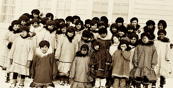 Inuit children from the western Arctic gather outside a residential school in this undated file photo. A new course will soon tell Grade 10 students in Nunavut more about the residential school experience. (FLEMMING/NWT ARCHIVES: N-1979-050-0101)