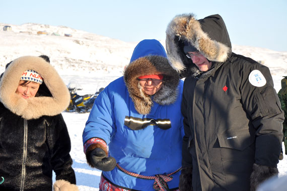 Prime Minister Stephen Harper, trainee seal hunter, prepares to watch a seal hunting demonstration with Canadian Ranger Dinos Tikivik (centre) and Nunavut MP Leona Aglukkaq during his visit to Iqaluit Feb. 23. Earlier that day, Harper announced $11.1 million in adult basic education money for Nunavut Arctic College, to be spent over five years. Altogether, the federal government will spend $27 million on adult education across the three territories, through the Canadian Northern Economic Development Agency. (PHOTO BY DEAN MORRISON)