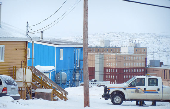 Iqaluit RCMP members confer with each other outside house 2200 on Apex Road just before 10:00 a.m. Feb. 17, following the peaceful resolution of what they call a