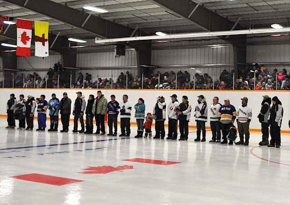 Pond Inlet hockey players stand on the ice during for the official opening of their new arena. (PHOTO COURTESY OF THE GN)