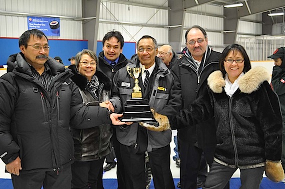 Nunavut Premier Eva Aariak presents a hockey trophy to Pond Inlet's Mayor Jaykolasie Killiktee during the March 23 opening of that community's new arena. Accompanying Aariak on the trip: James Arreak, minister of Culture, Language, Elders and Youth (far right), Tununiq MLA Joe Enook (second from right), and Nunavut MP Leona Aglukkaq (right). (PHOTO COURTESY OF THE GOVERNMENT OF NUNAVUT)