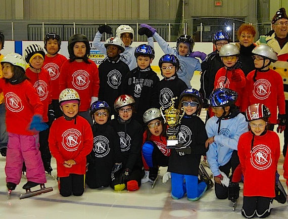 Students from Iqaluit's elementary schools pose on the ice at the Arctic Winter Games arena on March 31 with the new John Sands Iqaluit Inter-school champion cup, sponsored by Sands, a former 1956 and 1960 Olympic speed skater. The event saw participants, some of whom had never speed-skated before, competing on the ice. (PHOTO BY JANE GEORGE)