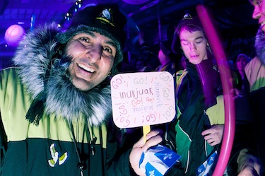 Inukjuak's Aftab Khan, Nunavik mission staff for Team Nunavik-Quebec's badminton team, holds up a sign created by kids in Inukjuak for him to hold March 4, 2012, at the Arctic Winter Games opening ceremonies in Whitehorse, Yukon. The Nunavik team has 53 athletes and six cultural performers.(PHOTO COURTESY OF THE KRG/MATHIEU COUTURE)