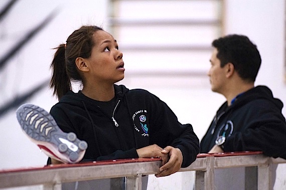 Inukjuak's Deseray Cumberbatch stretching before the Two-foot High Kick event March 6 at the Arctic Winter Games in Whitehorse, Yukon, as coach Tommy Palliser stands in the background. Cumberbatch placed second in the event and came first in Arm Pull for her second and third ulus of the games. (PHOTO COURTESY OF THE KRG/MATHIEU COUTURE)