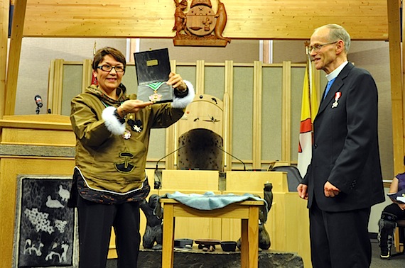 Nunavut Commissioner Edna Elias, left, presents the Order of Nunavut medal to its first-ever recipient, the retired Rev. Michael Gardener, right, at a November 2011 ceremony at the territorial legislature. (PHOTO BY SARAH ROGERS)