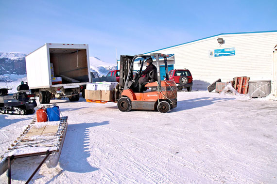 Alex Nakashuk loads the truck which will take fish to the airport and markets far from Pangnirtung. (PHOTO BY SARAH MCMAHON)