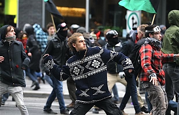 Protesters throwing rocks at police on Viger Street during student demonstration outside the Palais de Congrès on April 20. Hundreds of student protesters gathered around the Palais des congres for a second day Saturday outside a hotel where a Plan Nord job fair is underway. (PHOTO BY DARIO ALAYA/MONTREAL GAZETTE/POSTMEDIA NEWS)