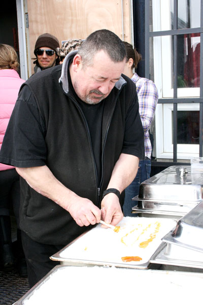 Iqaluit resident Claude Martel enjoys tire d'érable — or sugar on snow — at the francophone centre in Iqaluit at a May 6 sugar shack event. The event attracted nearly 100 people, who ate a brunch of brunch of eggs, sausages and baked beans and listened to live music performed in French and English by the Coffee House Band. (PHOTO BY DAVID MURPHY)