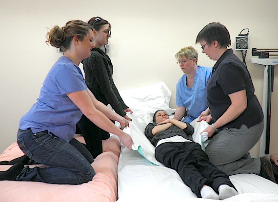Physiotherapist Connie Lee (right) demonstrates patient transferring techniques, practicing with first-year nursing students at Nunavut Arctic College in Iqaluit. May 6 marked the start of National Nurses Week, which runs until May 12, the birthday of Florence Nightingale, the founder of modern nursing. Read more about nursing in Nunavut later on Nunatsiaqonline.ca. (PHOTO BY RADHIKA SHASTRI)