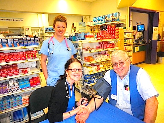 First year Nunavut Arctic College nursing students Rebecca Fada and Tiffany Withers take a blood pressure reading May 11 on Dave Seamone at Iqaluit's Northmart May 11, part of their National Nursing Week activities. (PHOTO COURTESY OF NAC)
