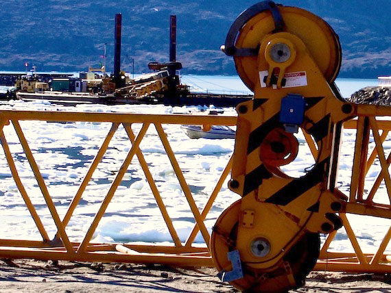 A week after a crane working on the $17-million new port facility in Pangnirtung tumbled over, the 120-tonne piece of heavy equipment still lies its side on the dredging platform while other pieces of machinery lie on the shore. The port was to be finished this summer. Meanwhile, contractors with Industry Canada are looking for a new crane that could be shipped in to complete the remaining work. Mayor Sakiasie Sowdluapik said June 22 that he's not worried about any serious delays to the harbour's completion: he's been assured that the port will be finished by October. (PHOTO BY SARAH MCMAHON)