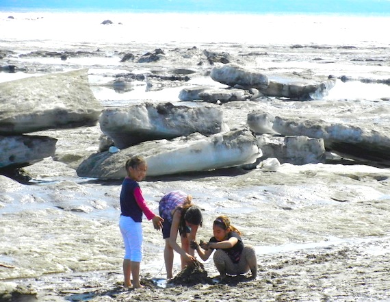 Kids in Kuujjuaq build a sand castle down by the ice floes in the Koksoak River June 2 as the temperatures reach 26 C, about 10 degrees above the average high temperature. The heat wave is predicted to continue through this week in Nunavik's largest community, with a high of 25 C forecast again for June 3. (PHOTO BY JANE GEORGE)