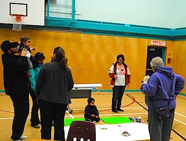 Iqaluit residents mingle at the Nanook School in Apex during the sustainability exhibit, sharing ideas and stories. (PHOTO COURTESY DON GRANT)