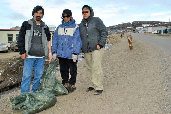 Tony Ashoona, Luukie Markoosie and Minnie Nookiguak of Iqaluit are among many volunteers from the Tukisigiarvik centre who began a big cleanup of the little creek valley that runs by the hospital to the beach this past week. (FILE PHOTO)
