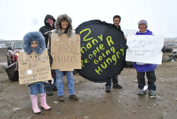 Leesee Papatsie (first on the right) with Imoe Papatsie, Louisa Willoughby, Brian Willoughby and Simeonie Willoughby at the start of a demonstration against high food prices held June 9 across the road from the Northmart store in Iqaluit. In spite of wet snowy weather, between 40 and 50 people showed up to hold placards and express their discontent with high food prices and hunger in Nunavut. (PHOTO BY JIM BELL)
