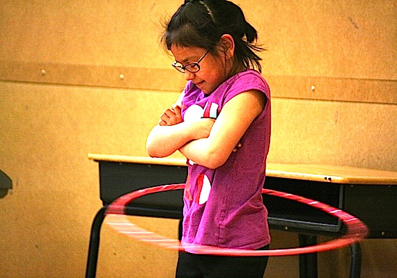 Gabrielle Pelky, who was one of three passengers to survive the Aug. 20, 2011 crash of Flight 6560 in Resolute Bay, shows off her skill with the hula-hoop at Joamie Elementary School's June 19 talent show in Iqaluit. Other acts at the show included break dancing, magic tricks, throatsinging, gymnastics and more. June 21 marks the last day of school before summer break kicks in for kids. (PHOTO BY DAVID MURPHY)