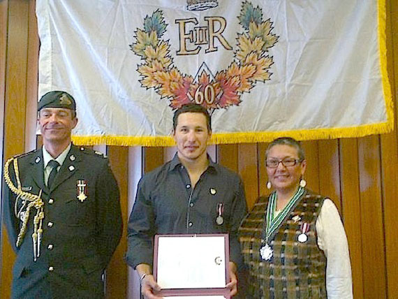 Jordin Tootoo (centre), who plays hockey for the Nashville Predators, poses this past weekend in Rankin Inlet with Nunavut Commissioner Edna Elias (right) moments after she presented him with a Diamond Jubilee medal, created to mark the 60th anniversary of Queen Elizabeth II’s accession to the throne. Some 60,000 Canadians will receive Diamond Jubilee medals throughout the year in recognition of their accomplishments. (PHOTO COURTESY OF J. TOOTOO)