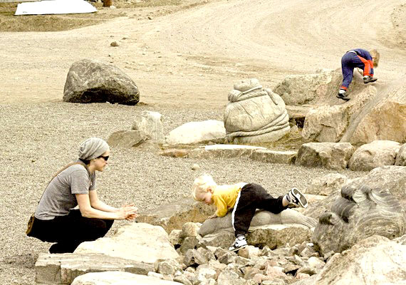 Angela Coulombe watches her sons Kyliam (left) and Ryder (right) climb rocks on sunny June 5 in Iqaluit. The high was predicted to reach 15 C degrees in Nunavut's capital — beating the previous high temperature of 11.1 C set in 1997, and much higher than the daily high of -7.8 C for June 5 in 1972. Today's record-breaker means the high temperature is about 10 degrees above normal for this time of year. (PHOTO BY DAVID MURPHY) 