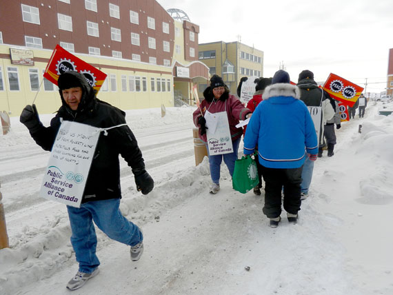 Members of the Nunavut Employees Union, a component of the Public Service Alliance of Canada, march in front of the Nunavut legislature in February 2012 during an information picket. (FILE PHOTO)