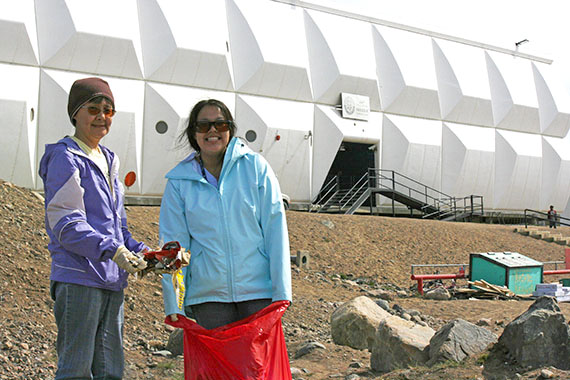 Jeannie Arnarjuaq (left) and Amanda Arnarjuaq pick up garbage around Nakusuk School on the morning of July 6 during the second Iqaluit community cleanup this summer. There was less interest in this effort than in the big cleanup of June 15, but many residents did come out to pick up trash from various hot spots around town. Volunteers enjoyed a free lunch at the Unikkaarvik Centre. (PHOTO BY DAVID MURPHY)