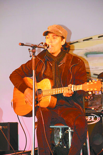 Singer-songwriter Simon Lynge, originally from Greenland, performs during a World Tunes Jam at the Big Top Tent July 1. (PHOTO BY SAMANTHA DAWSON)