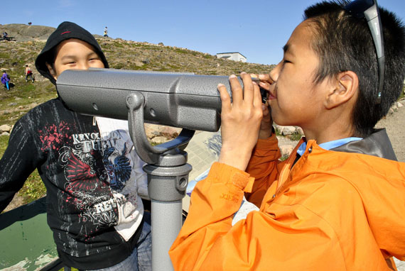 How far can you see? These two Iqaluit youngsters enjoyed using a pair of binoculars mounted at the lookout area near the pavilion at Sylvia Grinnell Park in Iqaluit during the Nunavut Parks Day event held July 21. (PHOTO BY JIM BELL)

 