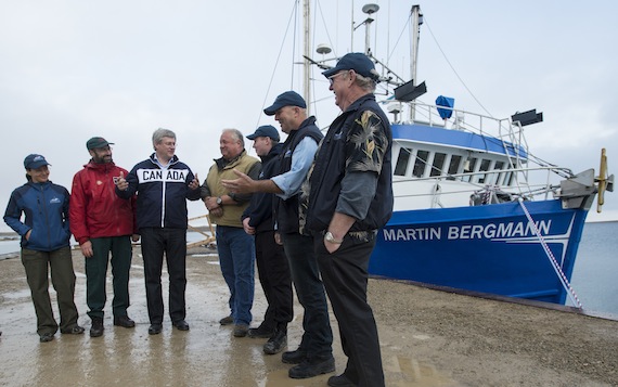 Prime Minister Stephen Harper chats with Captain Carrey Collinge and the crew of the Martin Bergmann research vessel prior to boarding the ship Aug. 22 in Cambridge Bay. (PHOTO COURTESY OF THE PMO)