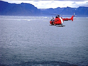 A Canadian Coast Guard helicopter flies an ice reconnaissance mission over Frobisher Bay on July 31. (FILE PHOTO)