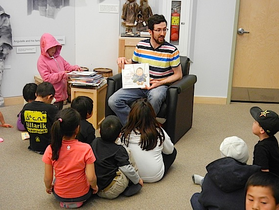 John Main, known to many Nunavummiut from his former job as a CBC North television reporter, reads to an attentive crowd of kids Sept. 25 in Cambridge Bay at the May Hakongak library and cultural centre, part of the library's daily Nunavut Literacy Week activities.  For more information on literacy week in Nunavut and suggestions for activities you can do with your children in Inuktitut, Inuinnaqtun, English and French, go to http://bit.ly/Q6PUWZ. (PHOTO BY JANE GEORGE)