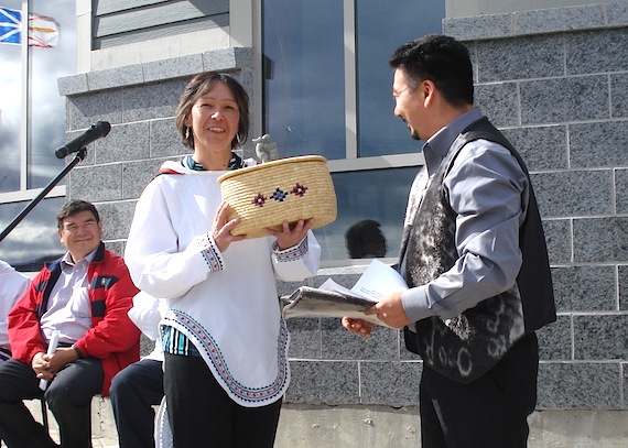 The Nunatsiavut government's president Sarah Leo holds a basket made by Martha and Lucassie Echalook of Inukjuak, a gift from Inuit Tapiriit Kanatami president Terry Audla,  at the Sept. 10 official opening of the Nunatsiavut assembly building in Hopedale, Labrador. 