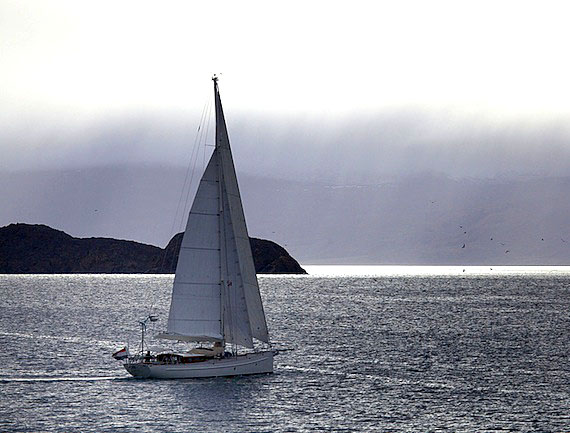 The 56-foot sailboat Tranquilo leaves Arctic Bay heading to the east coast of Ellesmere Island, where its captain will winter alone on board. (PHOTO BY CLARE KINES)
