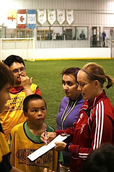 Coach Amy Vermeulen, formally of the Vancouver Whitecaps, goes over tactics with the kids at the Arctic Winter Games arena Sept. 16. The kids were split into groups and played their final games before a banquet ended the weekend. (PHOTO BY DAVID MURPHY)