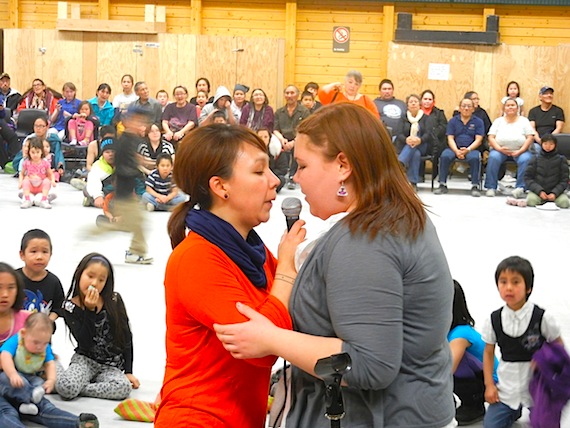 Madeleine Allakariallak of Iqaluit and Sarah Jancke of Cambridge Bay throatsing together Oct. 3 at the Kitikmeot Inuit Association's annual general meeting as Nunavut Premier Eva Aariak, sitting third from the right, watches. (PHOTO BY JANE GEORGE)
