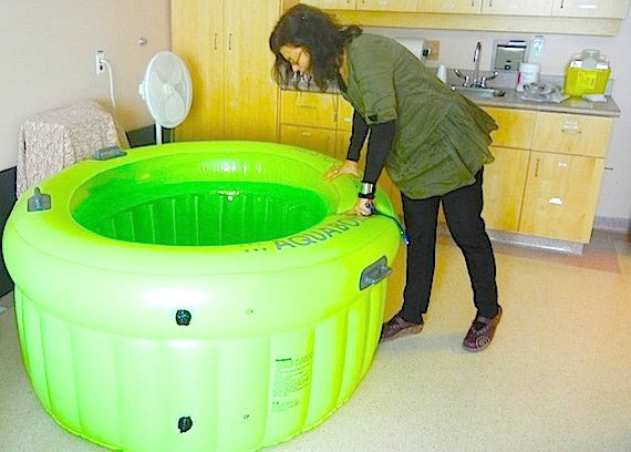 Midwife Anessa Maize, the acting regional manager at the Kitikmeot Regional Birthing Centre in Cambridge Bay, looks into the bright green inflatable pool where women who are giving birth can float to relieve their labour pains or even have their babies. Read more later on Nunatsiaqonline.ca about how birth has come closer to home again in Cambridge Bay. (PHOTO BY JANE GEORGE)