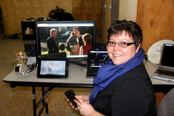 As a blizzard approaches Iqaluit Feb. 5, Heather Coman of Coman Communications, holding a GSM-capable iPhone, sits in front of different monitors and a tablet device to demonstrate live-streaming video and other high-speed services at the Coman Arctic building near the Iqaluit airport. Coman Communications, a subsidiary of Coman Arctic Ltd., is offering free wi-fi at the Tim Hortons outlet in the Northmart store, at Nunavut Arctic College, and at other locations around Iqaluit. Read more on nunatsiaqonline.ca. (PHOTO BY SAMANTHA DAWSON)