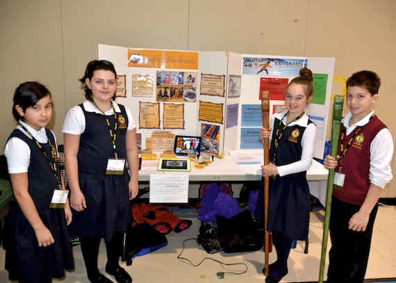 Students from the Ts8taïe school of Wendake, Coralie Ducheneau-Turgeon and Alison Hervieux-Picard, stand next to their science project about traditional Huron pottery. And on the left, Ts8taïe school students Amy-Ève Lapointe and Tommy Couture-Sioui by their exhibit about the snow snake game (Le jeu du serpent des neiges), one in which they studied the various effects (friction, weight, length, etc.) of the snow snake to determine its effect on speed. (PHOTO BY ISABELLE DUBOIS)