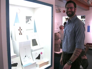 François Ouellette stands next to a display of his work at Iqaluit's museum.