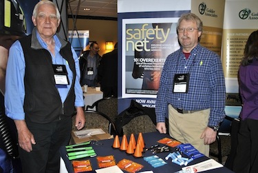 Martin van Rooy and Peter Bengts stand April 10 near the Workers' Safety and Compensation Commission's booth at Nunavut Mining Symposium in Iqaluit. Van Rooy and the WSCC received the Canadian North mining award handed out every year to a government or organization active in the territory's mining industry. (PHOTO BY JANE GEORGE)