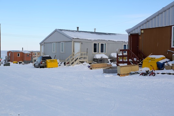 A view of Kugluktuk's new yellow wooden boxes by some of the community's houses where people can store their gas and propane safely. (PHOTO COURTESY  © 2013 UMINGMAK PRODUCTIONS INC.)