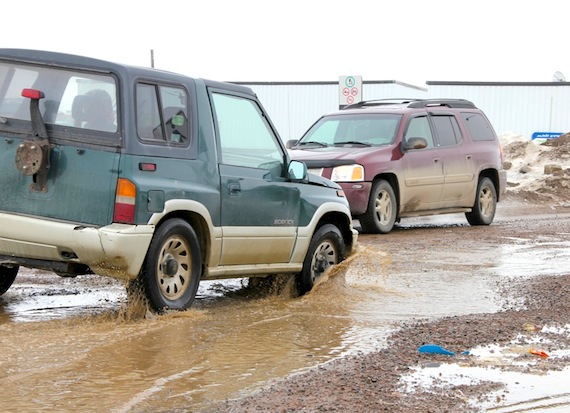 Iqaluit drivers plow through potholes and puddles near North Mart on May 1. At a city council meeting the night before, the condition of roads in Iqaluit came up for discussion, with Coun. Mark Morrissey asking that drainage issues on Iqaluit's Road to Nowhere be dealt with. People there “can’t even park in their driveways” and there is going to be a lot of runoff from all of the snow piled up, Morrissey said. “It’s certainly an uphill battle for public works,” Mayor John Graham said. In response to a question from Coun., Terry Dobbin, Graham told councillors that the director of public works would appear before council during the next meeting to address Iqaluit’s pothole problems. (PHOTO BY SAMANTHA DAWSON)