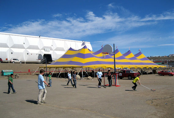 Summer seems well underway on a sunny afternoon June 26 in the centre of Iqaluit, where the Alianait Arts Festival big top tent stands ready for Nunavut's biggest musical event of the year as kids play a round of road hockey in warm, breezy weather. Eleven-degree temperatures seemed warmer in the hot sun. The Alianait Festival begins with an opening concert at 7:00 p.m. on June 28 at Nakasuk School, just behind the tent.
(PHOTO PETER VARGA)
