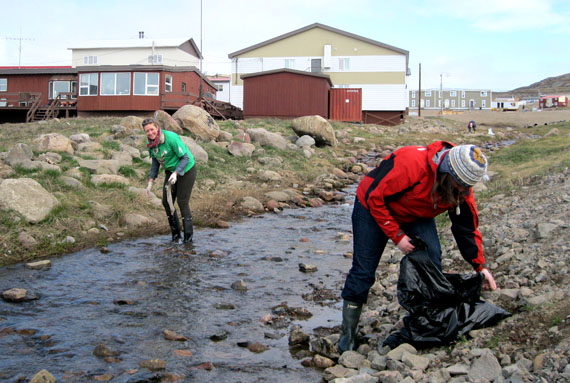 Volunteers wandered through Iqaluit on the morning of June 28 to gather up mounds of accumulated trash. Organized by the Government of Nunavut’s Department of Environment, the clean-up effort ran from 9 a.m. to noon. GN health department employees were assigned to clean up the area around the lower part of the Kuugalaaq, the little creek that empties near the breakwater. “It’s pretty difficult. This area collects a lot of garbage,” said health employee Lynn Matte. “We’ve seen strollers, bicycles, broken hockey sticks — and then the usual cigarette butts, pop cans, coffee cups.” Matte’s co-workers Michelle Issaluk (in the green promotional T-shirt) and Linnea Ingebrigtson (in the red jacket) picked up garbage in the creek. “We did this last year too, so we knew what to expect,” Matte said. (PHOTO PETER VARGA)