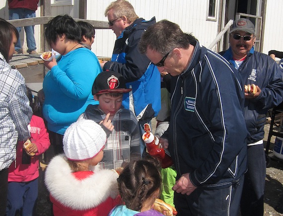 Donald Clark of Rankin inlet helps spread the ketchup for the younger ones during the Happy Fathers Day BBQ held June 15 in Rankin Inlet by Pulaarvik Kablu Friendship Centre of Rankin Inlet — in advance of June 16, Father's Day. Pulaarvik Kablu Friendship Centre, the only friendship centre in Nunavut, offers 13 to 15 programs, which benefit the residents of Rankin Inlet and the Kivalliq region, including counselling, teaching traditional skills and providing the local school bus service. (PHOTO BY DOUG MCLARTY/ARCTECH DESIGN AND SERVICES)