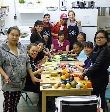 Members of the Igavik Club sit around the table in their new kitchen at the Umiujaq research station. (PHOTO COURTESY OF THE IGAVIK CLUB)